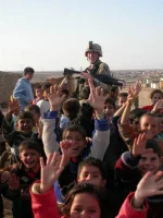 iraq.children_cheering_soldier.webp