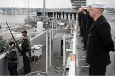 US_Navy_070116-N-0684R-147_Security_personnel_man_a_.50-caliber_machine_gun_while_Sailors_man...webp