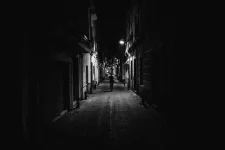 143139164-woman-walking-alone-in-the-street-late-at-night-narrow-dark-alley-unsafe-female-sil...webp