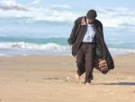 old_man_walking_on_beach-t2.jpg