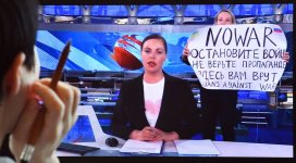Russian woman holding sign.jpg