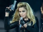 madonna-flaunted-pistols-and-ak47s-just-hours-after-the-colorado-shooting-300x225.jpg