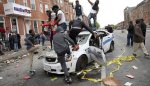 Thugs-take-a-spring-break-on-police-car-in-Baltimore.jpg