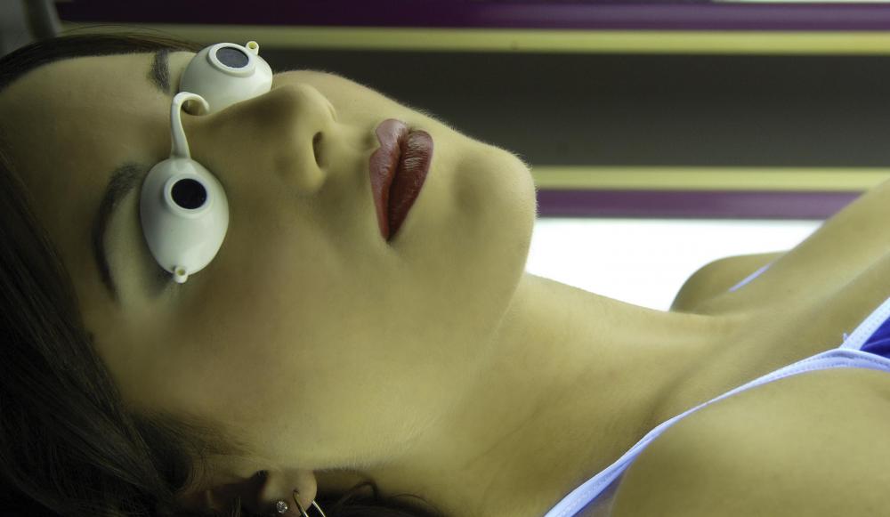 woman-lying-down-in-tanning-booth-with-goggles.jpg