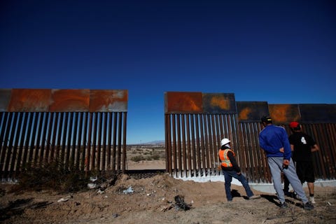 a-worker-chats-with-residents-at-a-newly-built-section-of-the-us-mexico-border-fence-at-sunland-park-us-opposite-the-mexican-border-city-of-ciudad-juarez-mexico-january-26-2017-reutersjose-luis-gonzalez.jpg